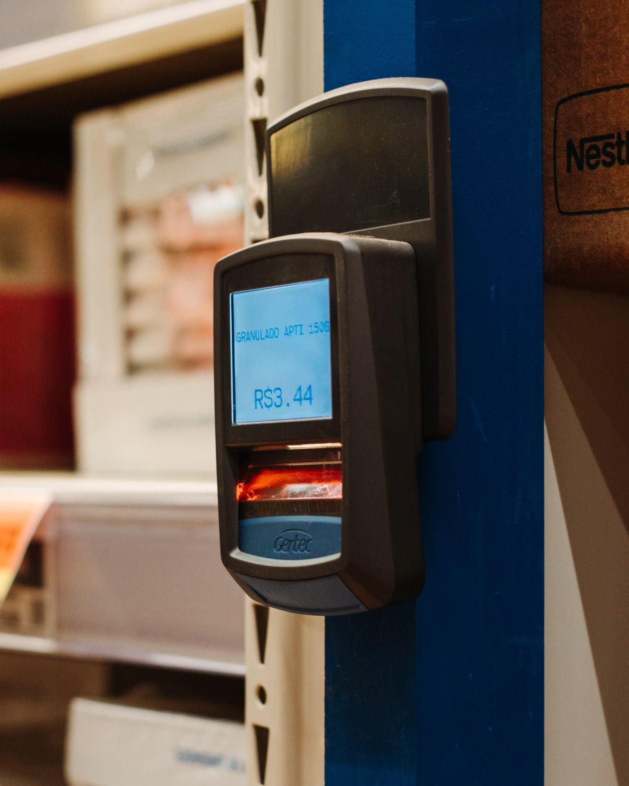 Handheld barcode scanner showing a product price in a retail shop