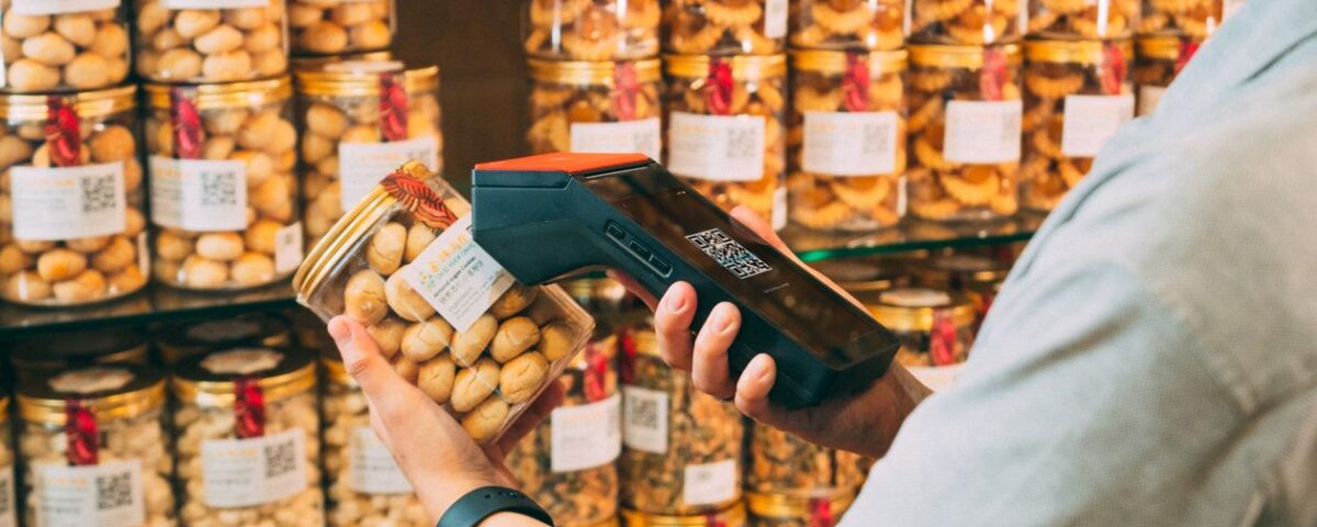 Barcode scanning a product at a retail store counter in Pakistan