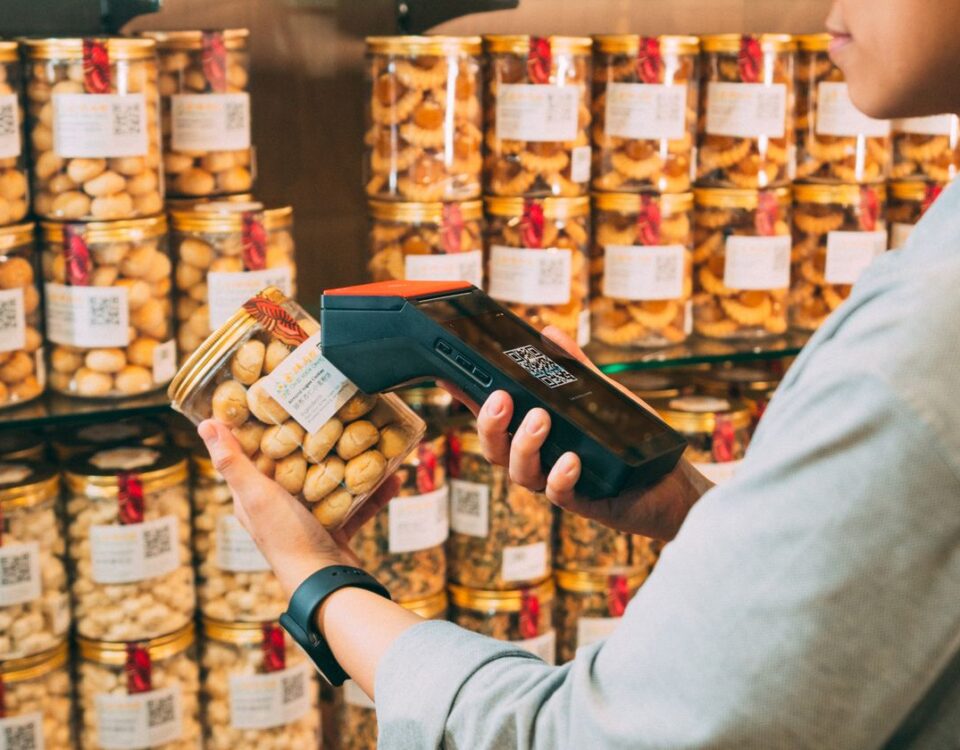 Barcode scanning a product at a retail store counter in Pakistan