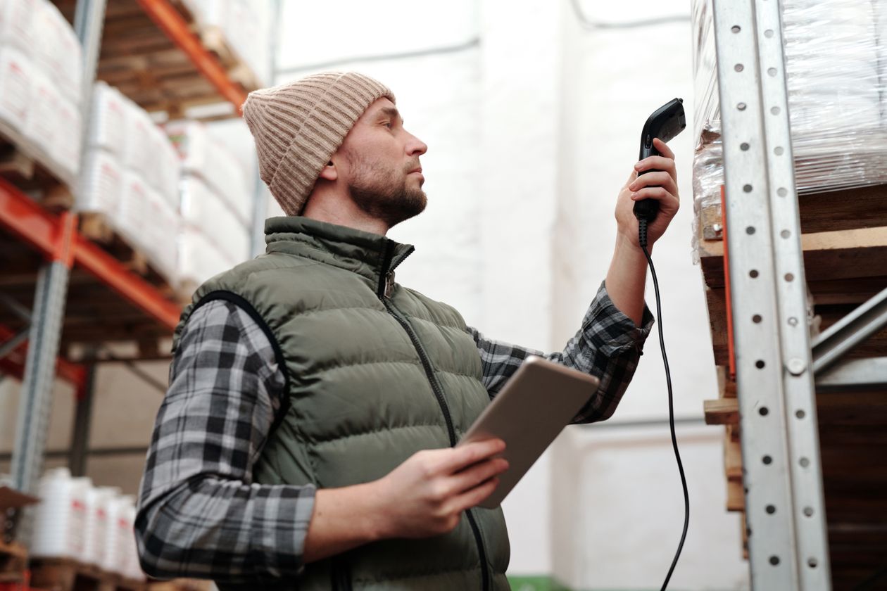 Staff scanning stock with a handheld scanner during a bulk product import