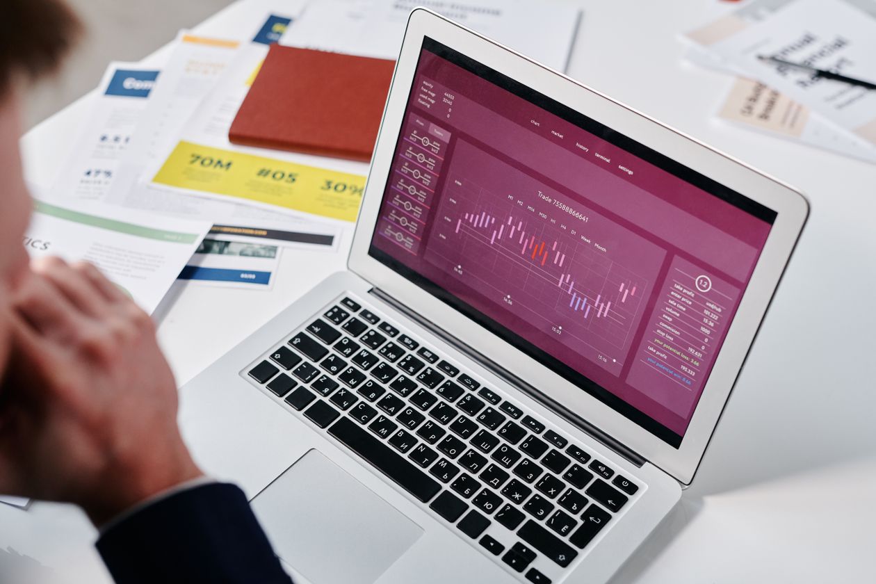Owner reviewing centralised sales reports for multiple retail branches