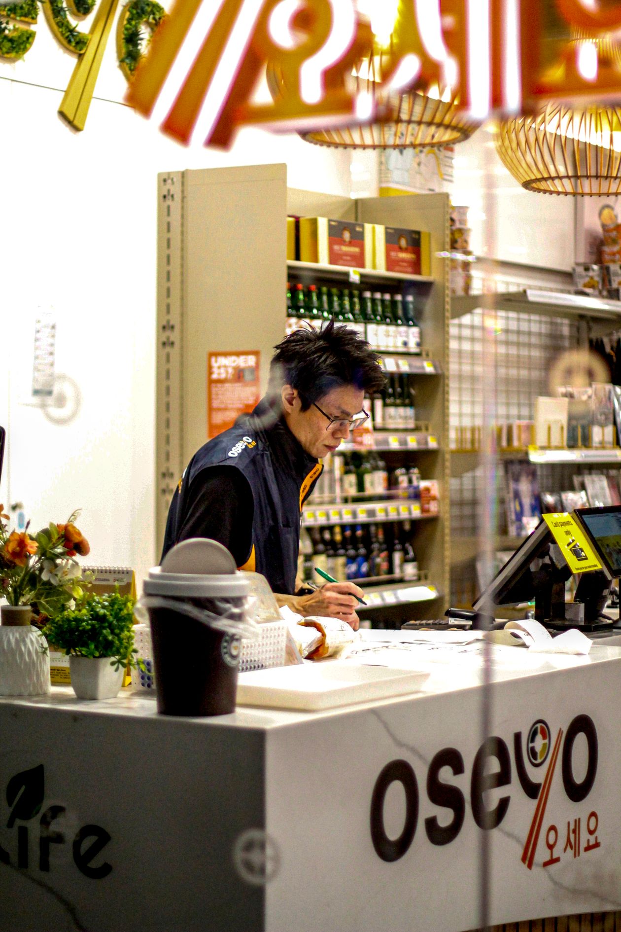 Cashier using a retail POS system at a supermarket checkout counter