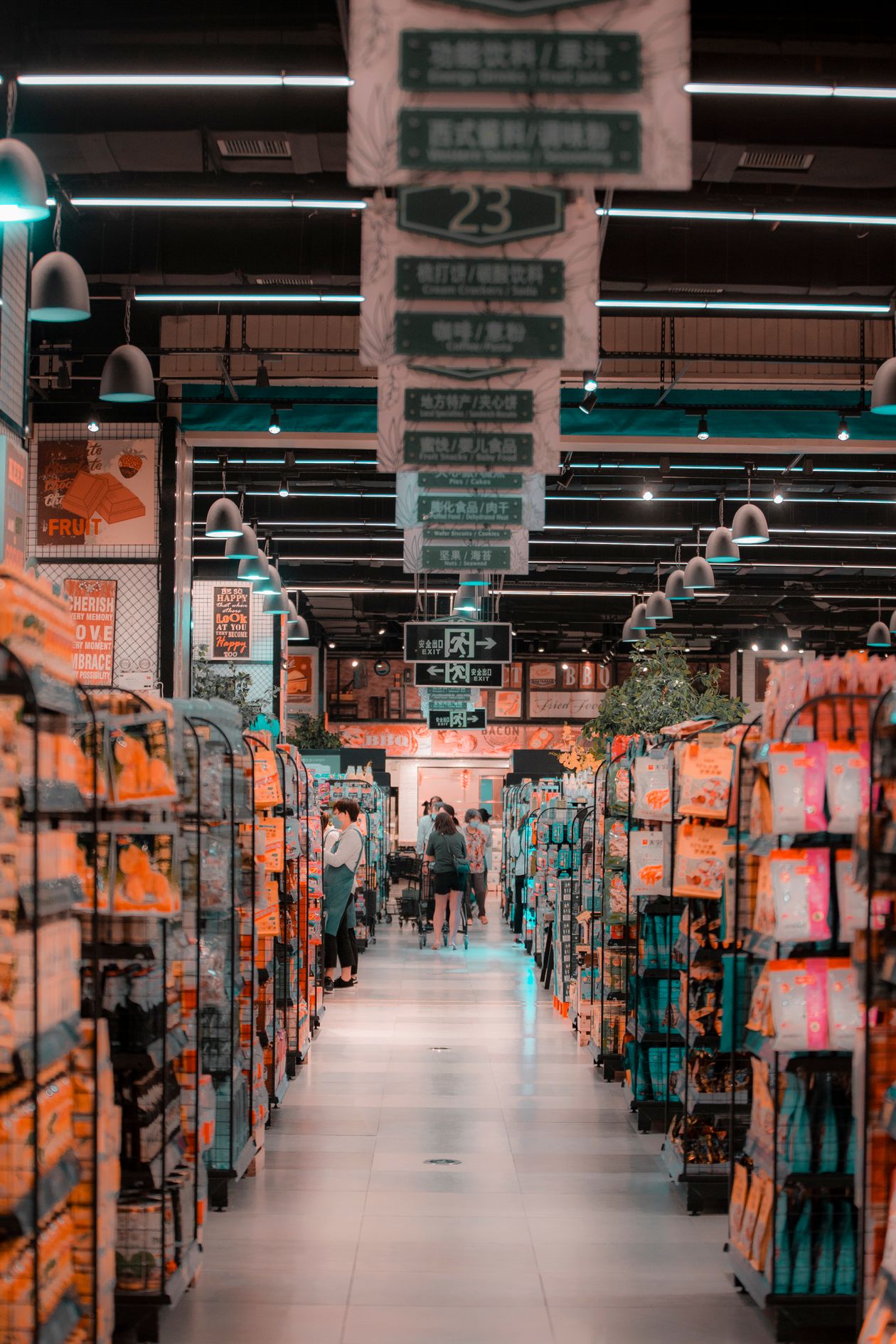 Shoppers in a supermarket aisle where retail stock moves daily